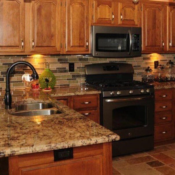 Warm wood kitchen with granite countertops and appliances